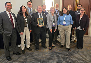 APA Staff With Award